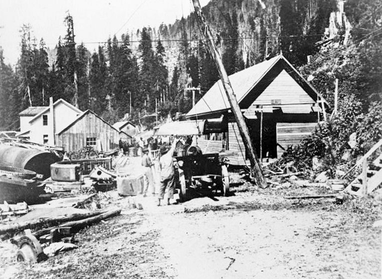 Nooksack Falls Hydroelectric Plant, Glacier Washington Historic view just west of powerhouse during reconstruction of penstocks and replacement of original Francis turbine with Pelton wheels in 1912; looking northwest. (Photographer unknown, circa 1912.)