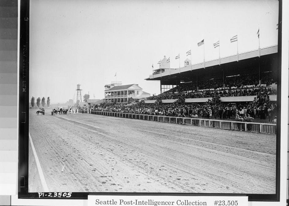 Longacres Park Horse Track, Renton Washington Photocopy of photograph. (Original is No. PI-23505 in the Seattle Post-Intelligencer Collection at the Museum of History and Industry (MOHAI), Seattle, WA. A print from the original negative can be ordered from MOHAI.) A 1940 view looking SSW at track at Clubhouse in center and Original Grandstand on right. Note addition of small announcer's booth on Grandstand roof and glazed enclosure at south end of Grandstand seating.