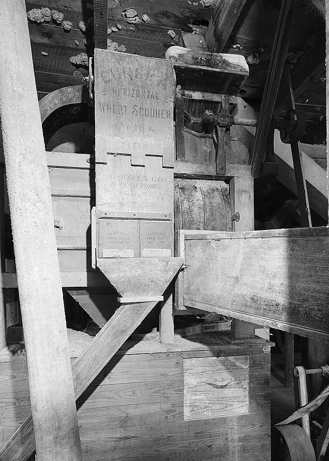 Bunker Hill Grist Mill - Cline and Chapman Roller Mill, Bunker Hill West Virginia Second floor, detail of Eureka horizontal wheat scourer, by S. Howes Company, (Silver Creek, NY). After leaving scourer, grain passed directly to the Midget Marvel Machine (1980)