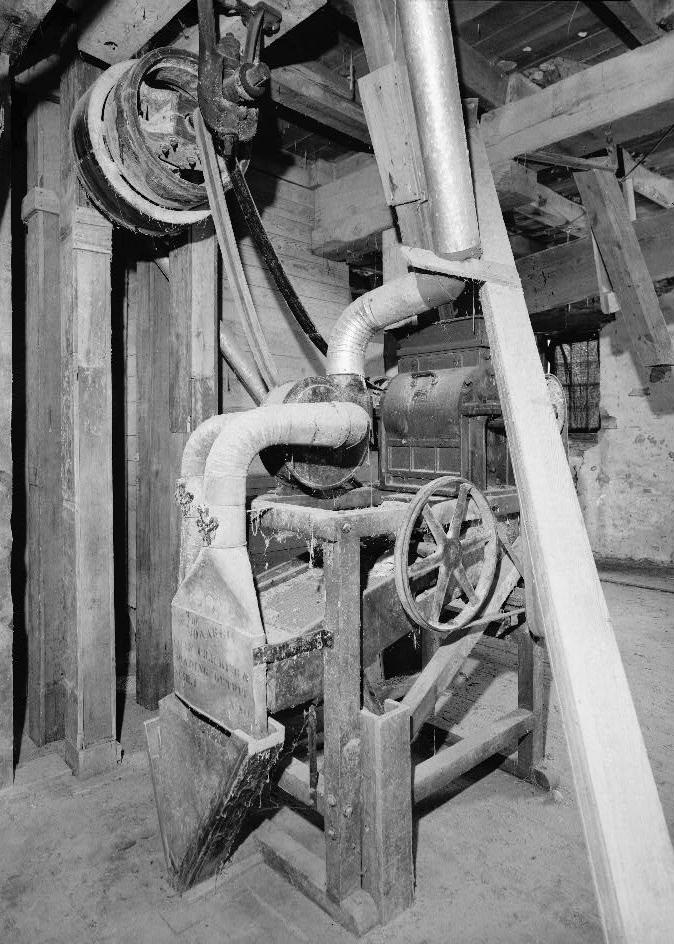 Bunker Hill Grist Mill - Cline and Chapman Roller Mill, Bunker Hill West Virginia Second floor, view of Monarch Company. Corn cracking machine, by Sprout, Waldron and Company, (Muncy, PA), which cut and diced corn to a uniform size, then separated it into three grades of cracked corn and corn meal and removed chaff (1980)