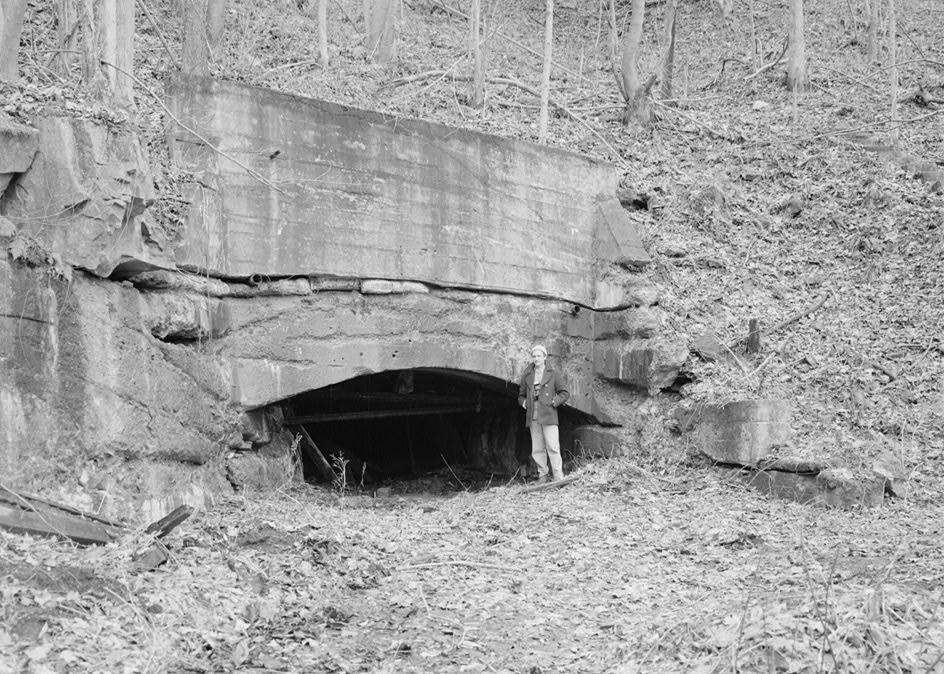 Kaymoor Coal Mine, South side of New River, Fayetteville West Virginia CONCRETE PORTAL OF MAIN DRIFT OPENING WITH ERIC DELONY SERVING AS A SCALE FIGURE (1986)