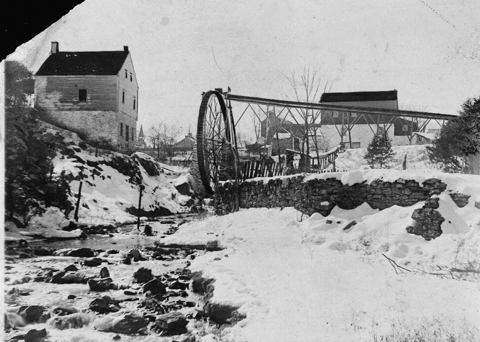 Thomas Shepherd's Grist Mill, Shepherdstown West Virginia WINTER VIEW OF WATERWHEEL IN DOWNSTREAM LOCATION SHOWING ELEVATED HEADRACE AND ENDLESS-WIRE POWER TRANSMISSION TO MILL (c. 1735)