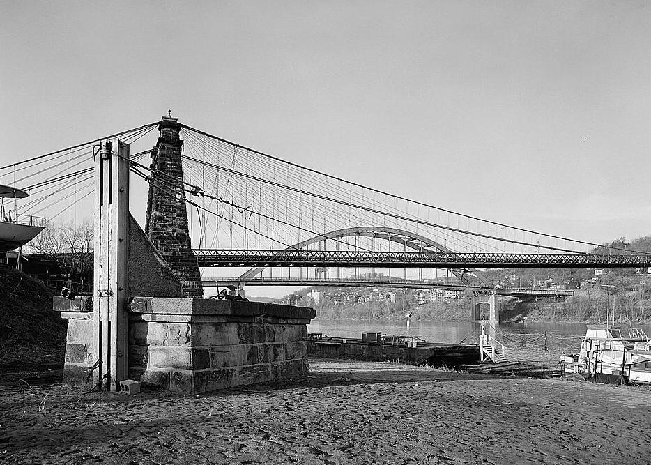 Wheeling Suspension Bridge, Wheeling West Virginia SOUTH ELEVATION VIEW OF MADISON HALF OF BRIDGE, WITH AUXILIARY SWAY BRACING ANCHOR IN FOREGROUND. 1976