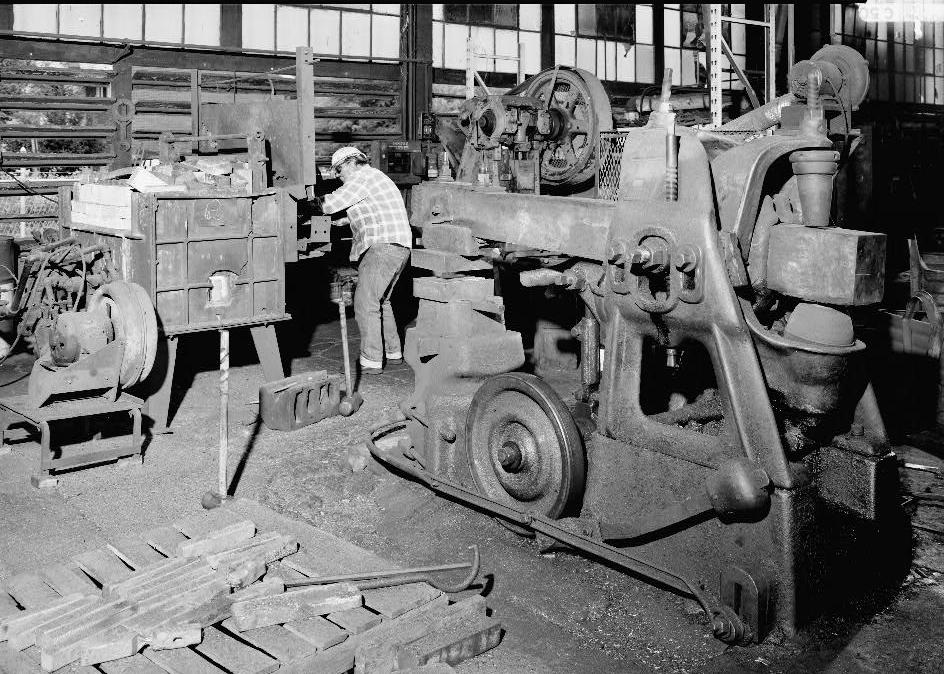 Warwood Tool Company, Wheeling West Virginia INTERIOR VIEW, WILLIAM GRAY AT SLOTTED TYPE FURNACE WITH A BRADLEY HAMMER IN THE FOREGROUND 1990